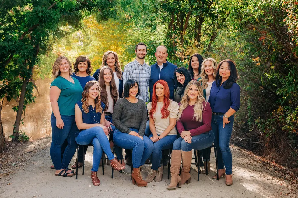 The Copperstone Dental team outdoors on a wooded trail in fall color
